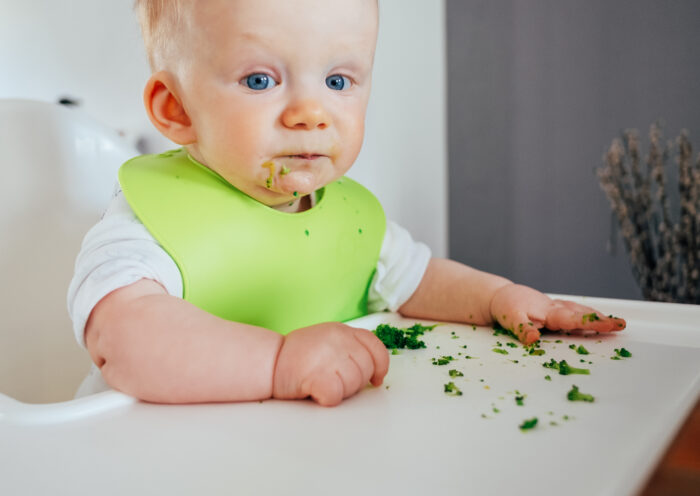 cute baby messing while eating