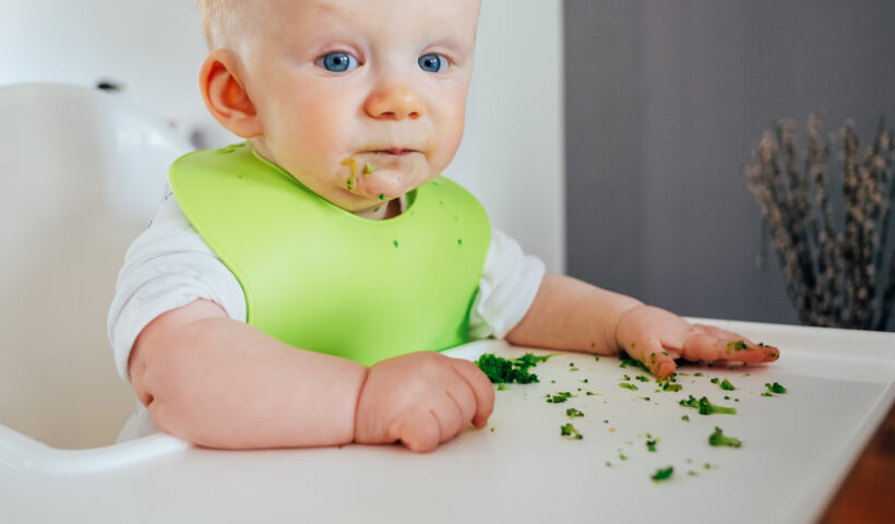 cute baby messing while eating